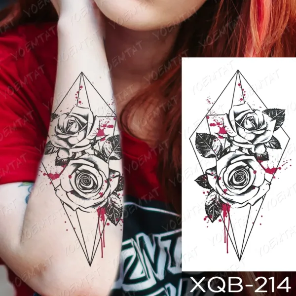 A temporary tattoo with geometric roses and red splatter on the arm.
