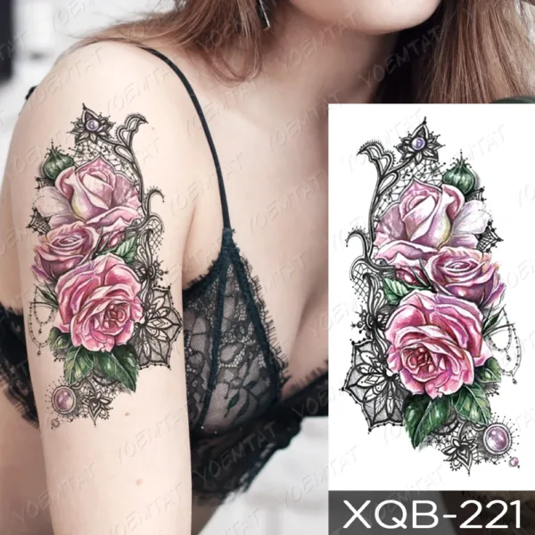 A temporary tattoo with pink roses and black lace design on the upper arm