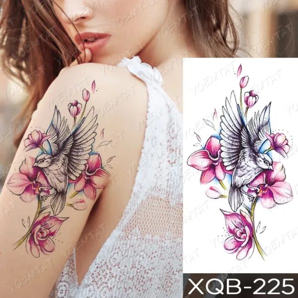 Temporary tattoo of a bird in flight with surrounding pink blossoms on a woman's shoulder