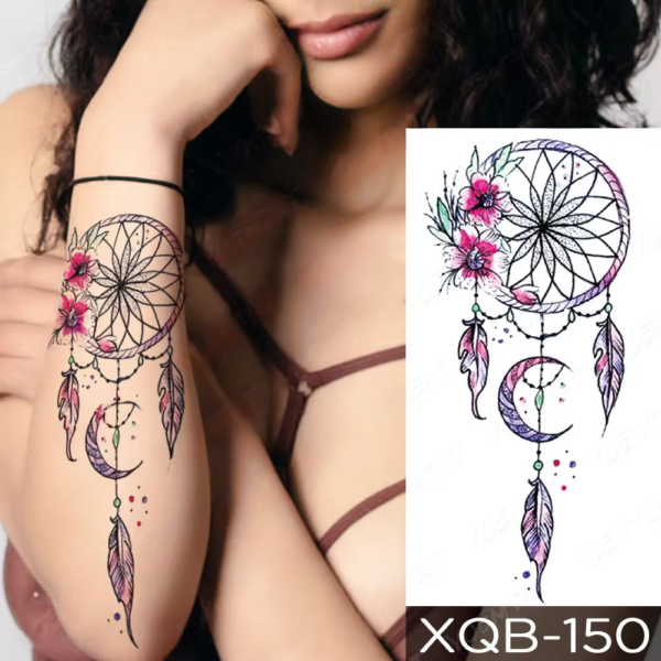A chic dreamcatcher tattoo graces a woman's forearm, flowers and feathers adding a touch of mystic beauty.