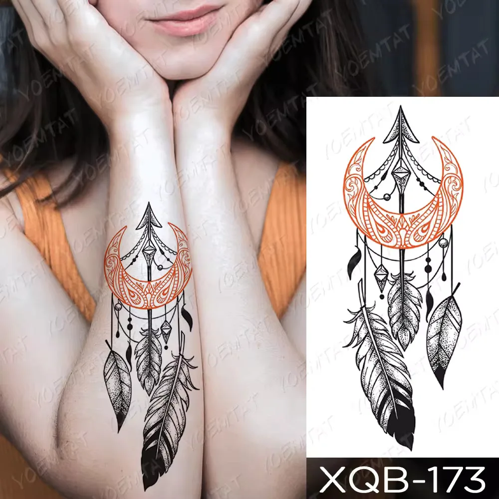 A temporary tattoo of a crescent moon dreamcatcher with feathers on the arm.